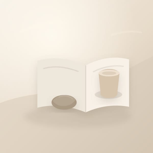 A quiet desk with an open journal, soft morning light, and a small stone beside a cup, suggesting released worry.